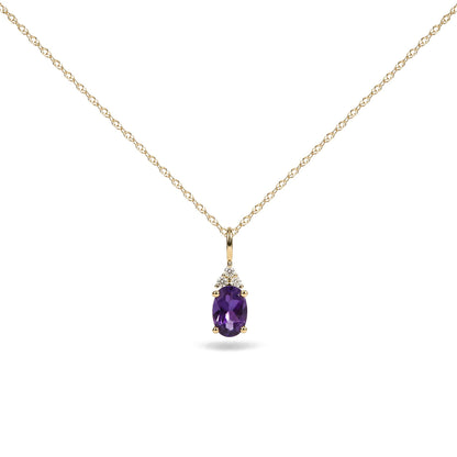 Close-up front view of a yellow metal necklace with an oval purple gemstone pendant, accented by three round white gemstones above it, shown on a white background.
