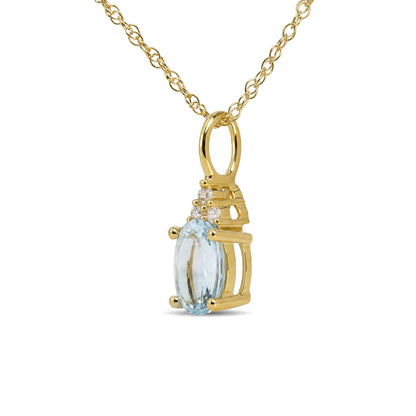 Close-up front view of a yellow metal necklace pendant featuring an oval blue gemstone in a prong setting, accented by round white gemstones in prong settings. The pendant hangs from a yellow metal chain.