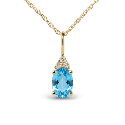 Close-up front view of a yellow metal necklace with an oval blue gemstone pendant accented by three round white gemstones in prong settings.