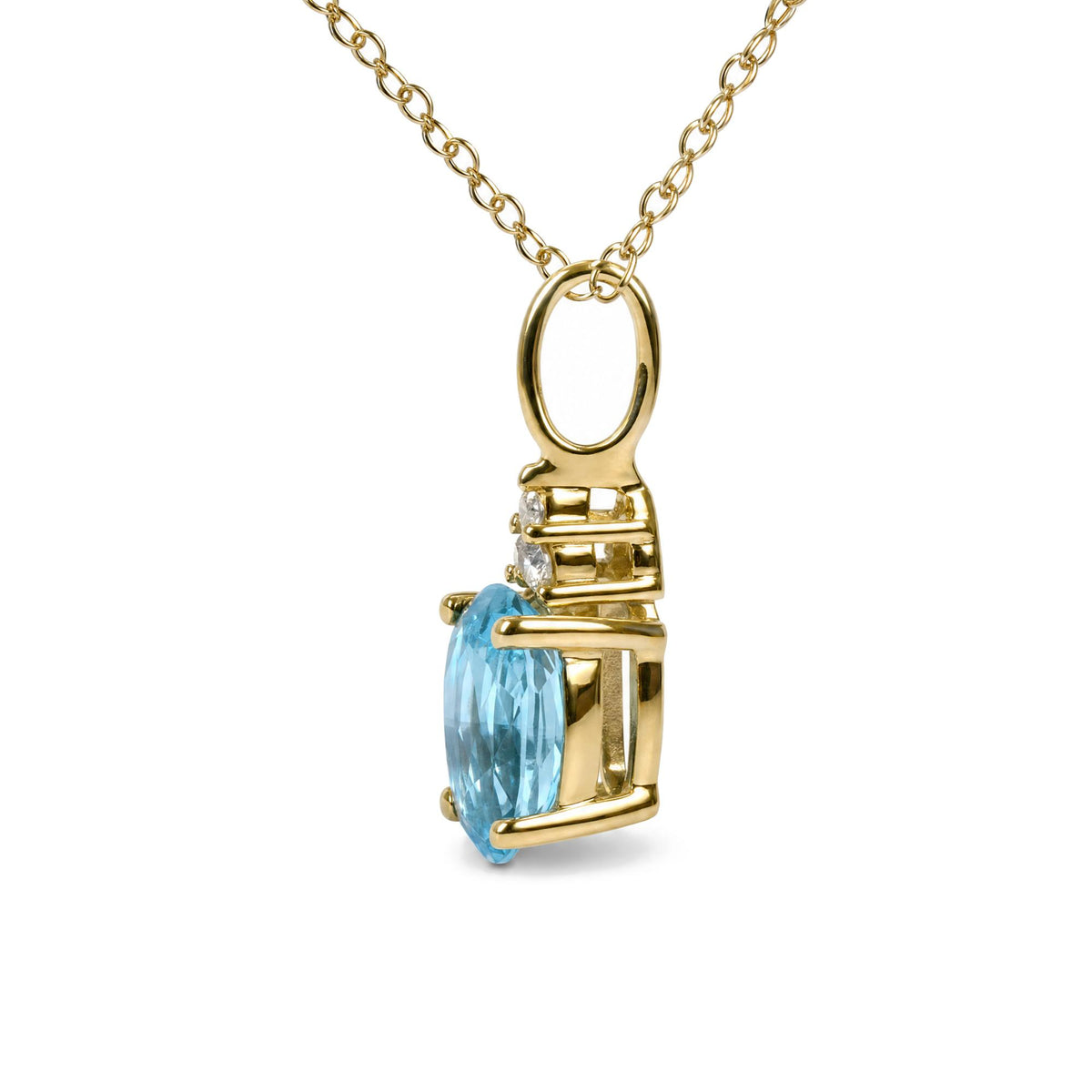 Close-up side angle of a yellow metal necklace with an oval-shaped blue gemstone and three small round white gemstones, shown on a white background.