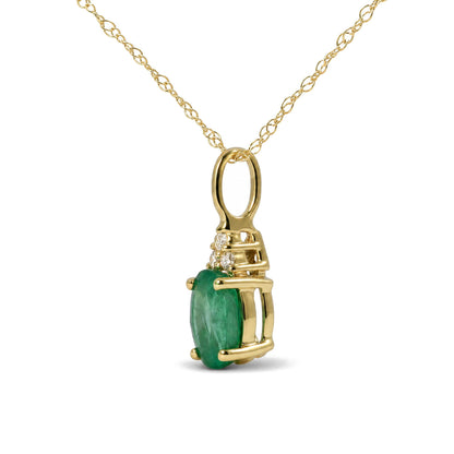 Yellow metal necklace with an oval green gemstone pendant accented by three round white gemstones in a prong setting, shown in a close-up angle.
