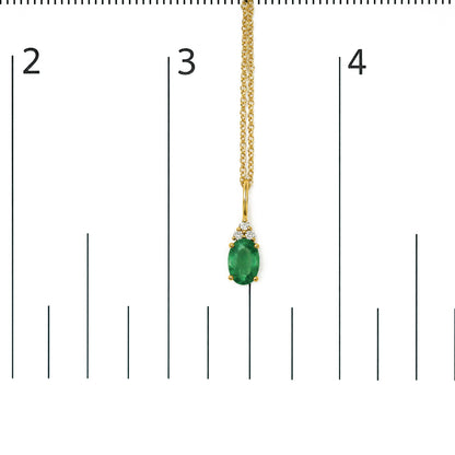 Yellow metal necklace with an oval green gemstone pendant accented by three round white gemstones in prong settings, shown on a scale, front angle.