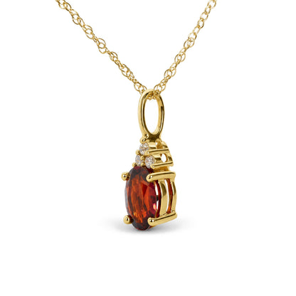 Close-up front angle of a yellow necklace with a pendant featuring an oval red gemstone surrounded by three round white gemstones in prong settings.