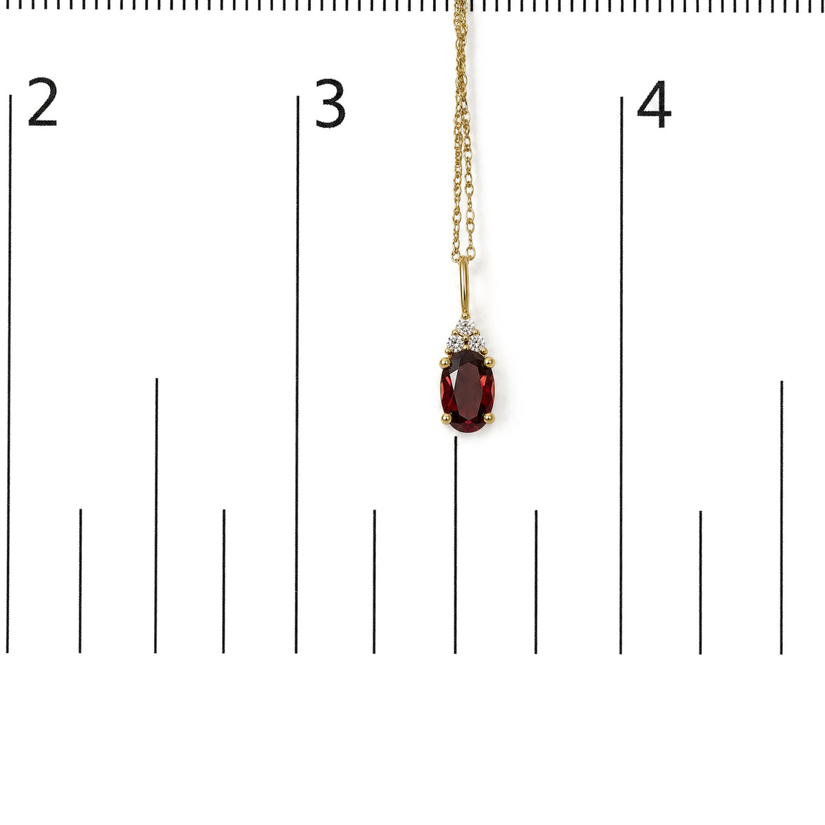 Yellow necklace with oval-shaped red gemstone pendant surrounded by three round white gemstones, shown hanging on a measurement scale, front angle.