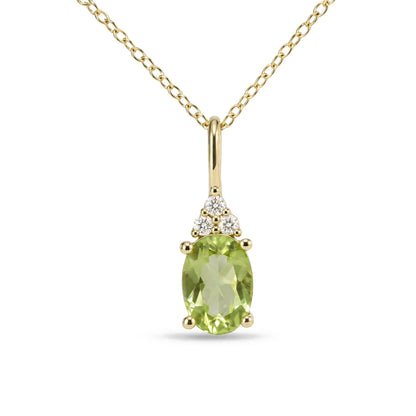 Close-up front view of a yellow metal necklace with an oval green gemstone pendant accented by three round white gemstones above it, shown on a white background.