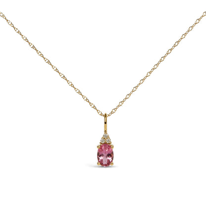 Close-up front view of a yellow metal necklace with an oval pink gemstone pendant accented by three round white gemstones in a prong setting.