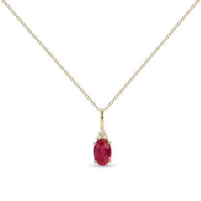 Close-up front view of a yellow metal necklace with an oval-shaped red gemstone pendant surrounded by three round white gemstones, all in prong settings.