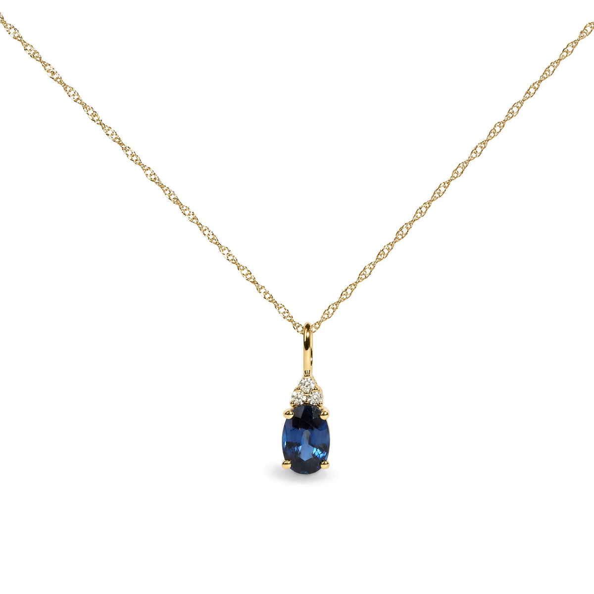Yellow metal necklace with a delicate chain, featuring a pendant with an oval-shaped blue gemstone framed by three round white gemstones in prong settings, shown in a close-up front view.