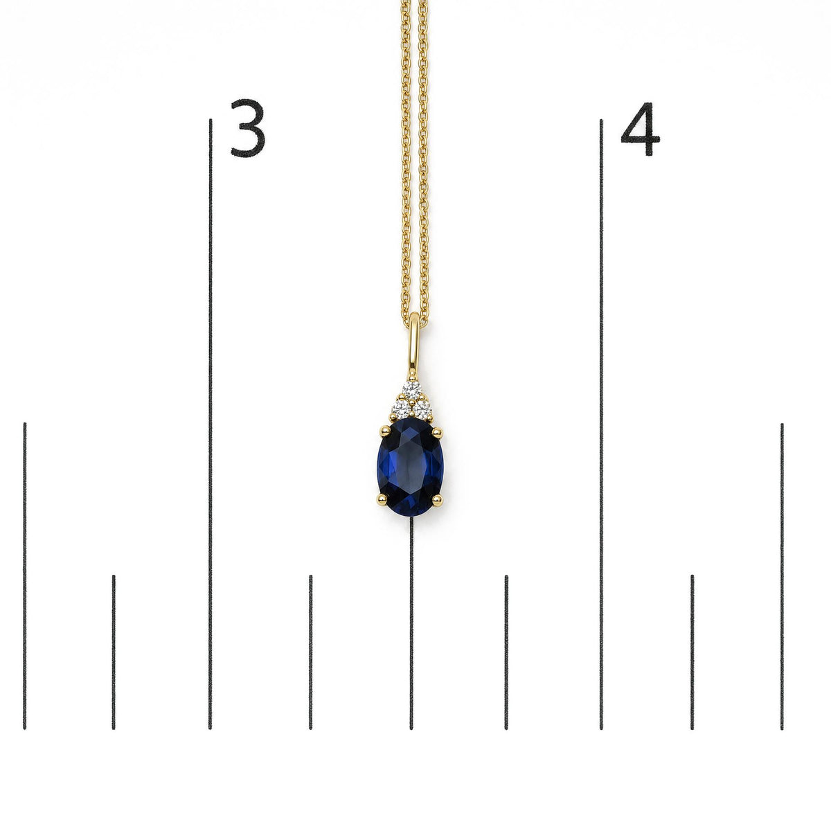 Yellow necklace with a blue oval gemstone pendant surrounded by three round white gemstones in prong settings, shown on a scale from a front angle.