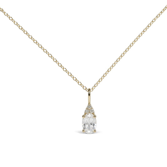 Close-up front view of a yellow metal necklace featuring a pendant with one oval white gemstone in a prong setting and three small round white gemstones above it, also in prong settings.