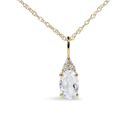 Close-up front view of a yellow metal necklace with an oval white gemstone pendant accented by three round white gemstones in prong settings.
