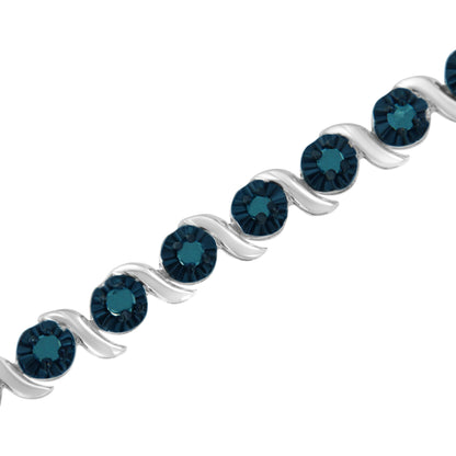 Close-up angled view of a white bracelet with alternating curved links and round blue gemstones in prong settings.