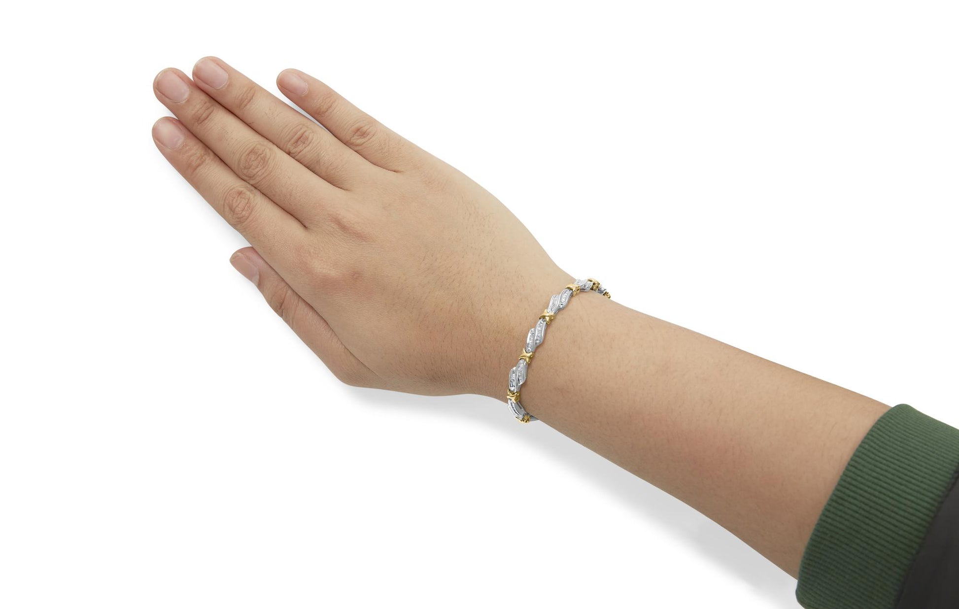 Bracelet with alternating yellow and white metal links and white baguette-shaped gemstones in channel setting, shown on a model’s wrist, angled from above.
