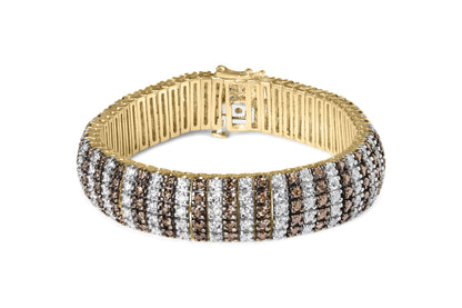 Yellow metal bracelet with alternating rows of white and brown round gemstones in prong settings, shown from a front angle.