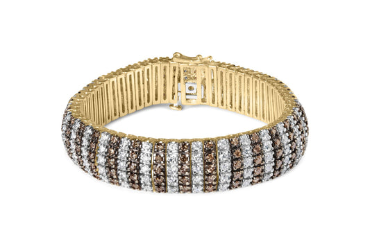 Yellow metal bracelet with alternating rows of white and brown round gemstones in prong settings, shown from a front angle.