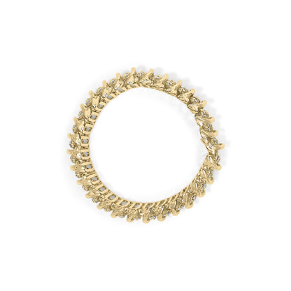 Top-down view of a yellow metal bracelet with round white gemstones in prong settings encircling the entire band.