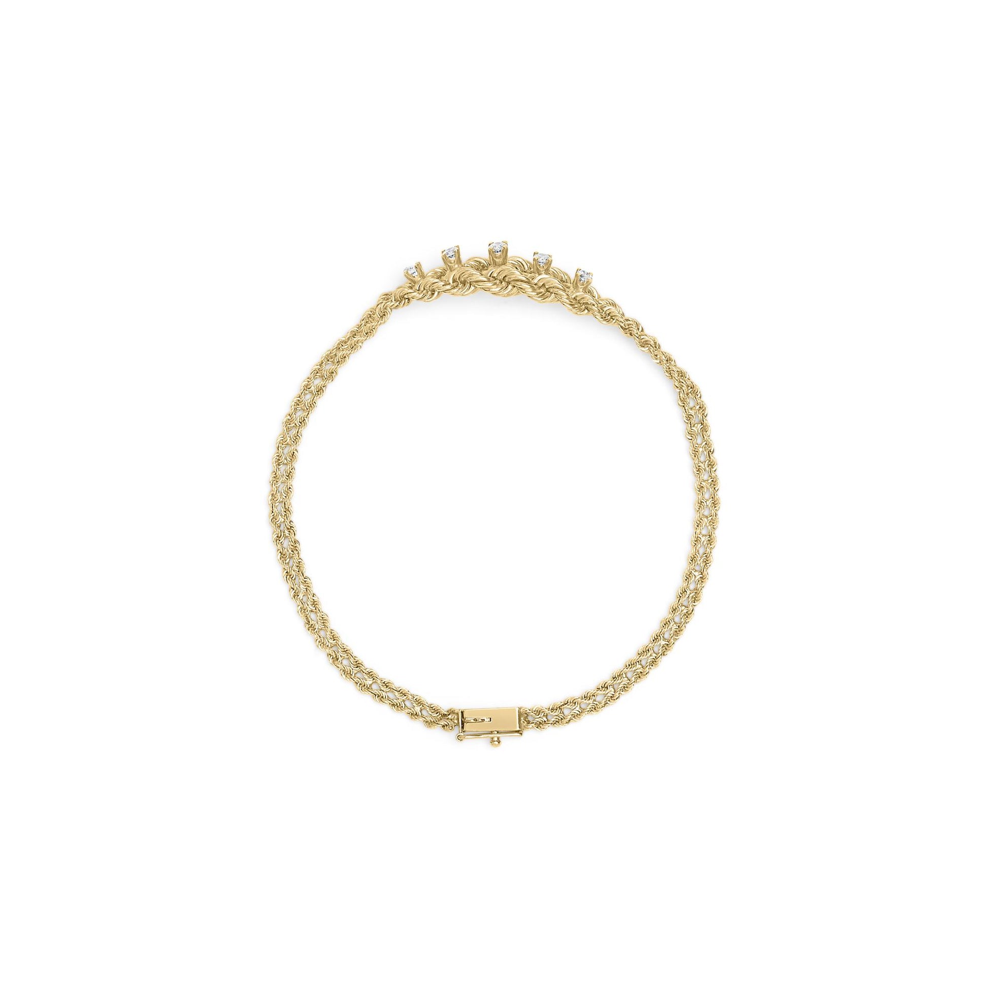 Top-down view of a yellow metal bracelet with a twisted rope design and five round white gemstones in prong settings near the clasp.
