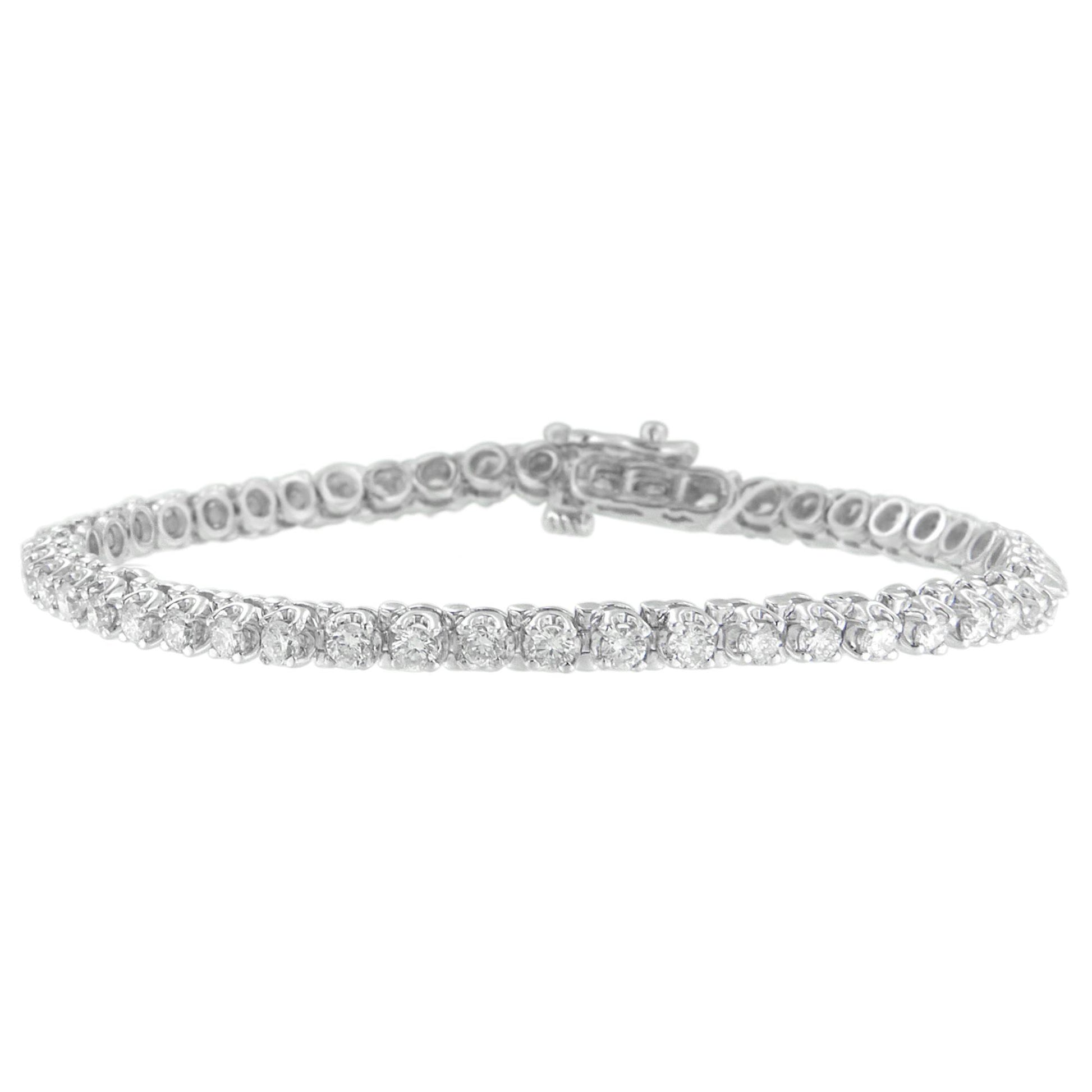 Close-up front angle of a white metal bracelet featuring round white gemstones in prong settings.