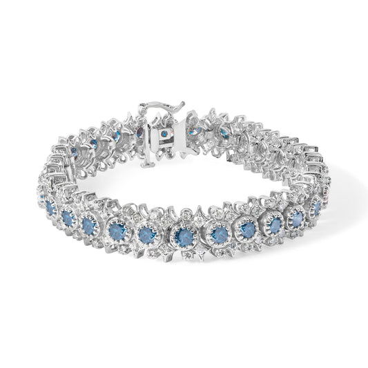 Close-up angled view of a white metal bracelet featuring round blue and white gemstones in prong settings arranged in a floral-like pattern.