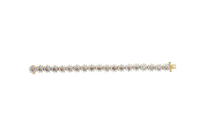 Top-down view of a yellow metal bracelet with alternating round champagne and white gemstones in prong settings.