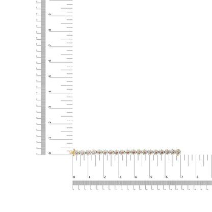 Yellow bracelet with alternating round white and champagne gemstones in prong settings, laid flat on a ruler for size reference, shot from above.