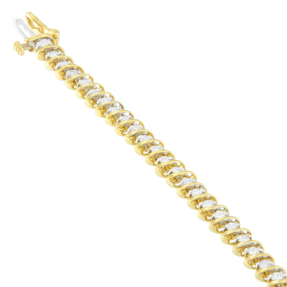 Yellow metal bracelet with prong-set round white gemstones, shown in a diagonal close-up angle.