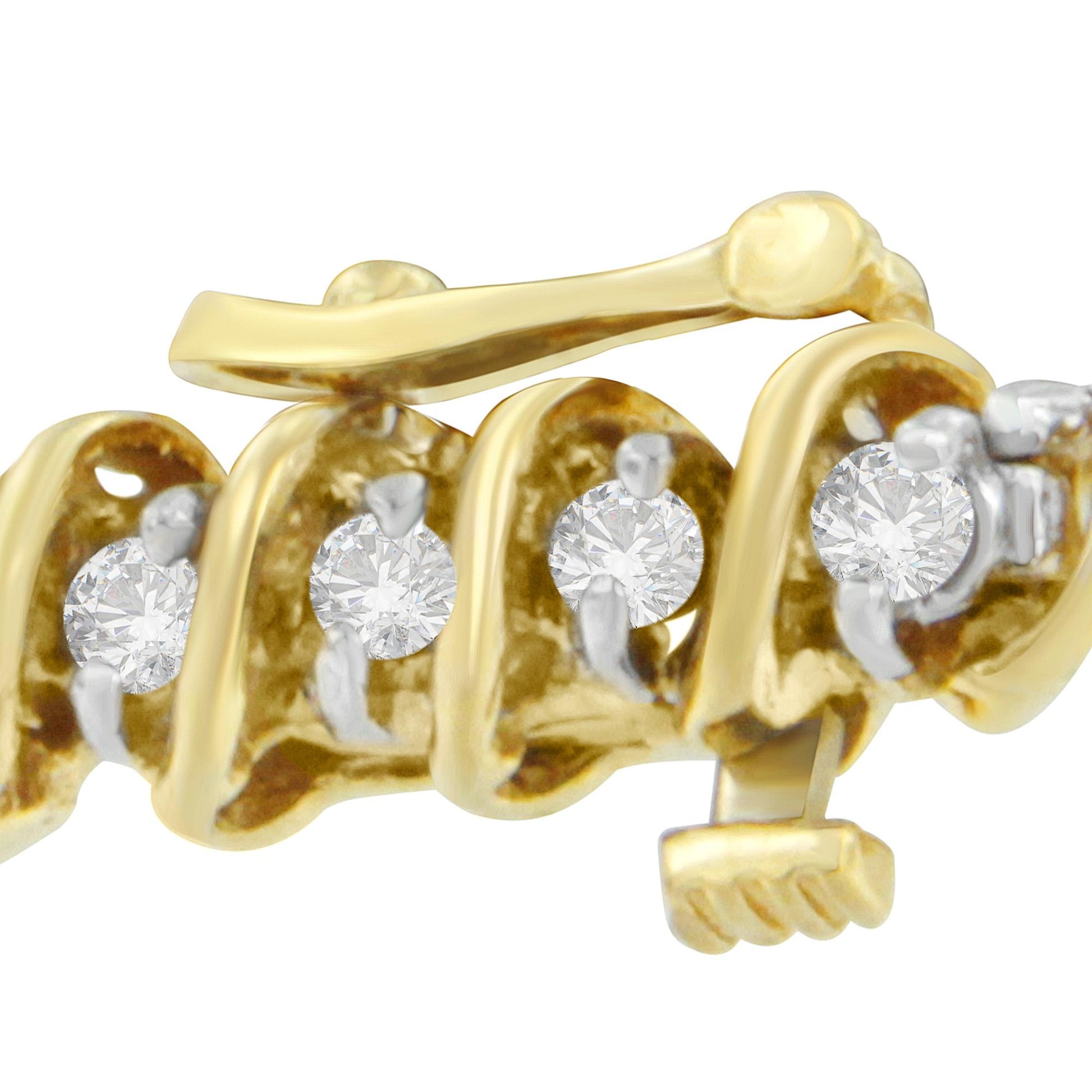 Close-up angled view of a yellow metal bracelet featuring round white gemstones in prong settings.