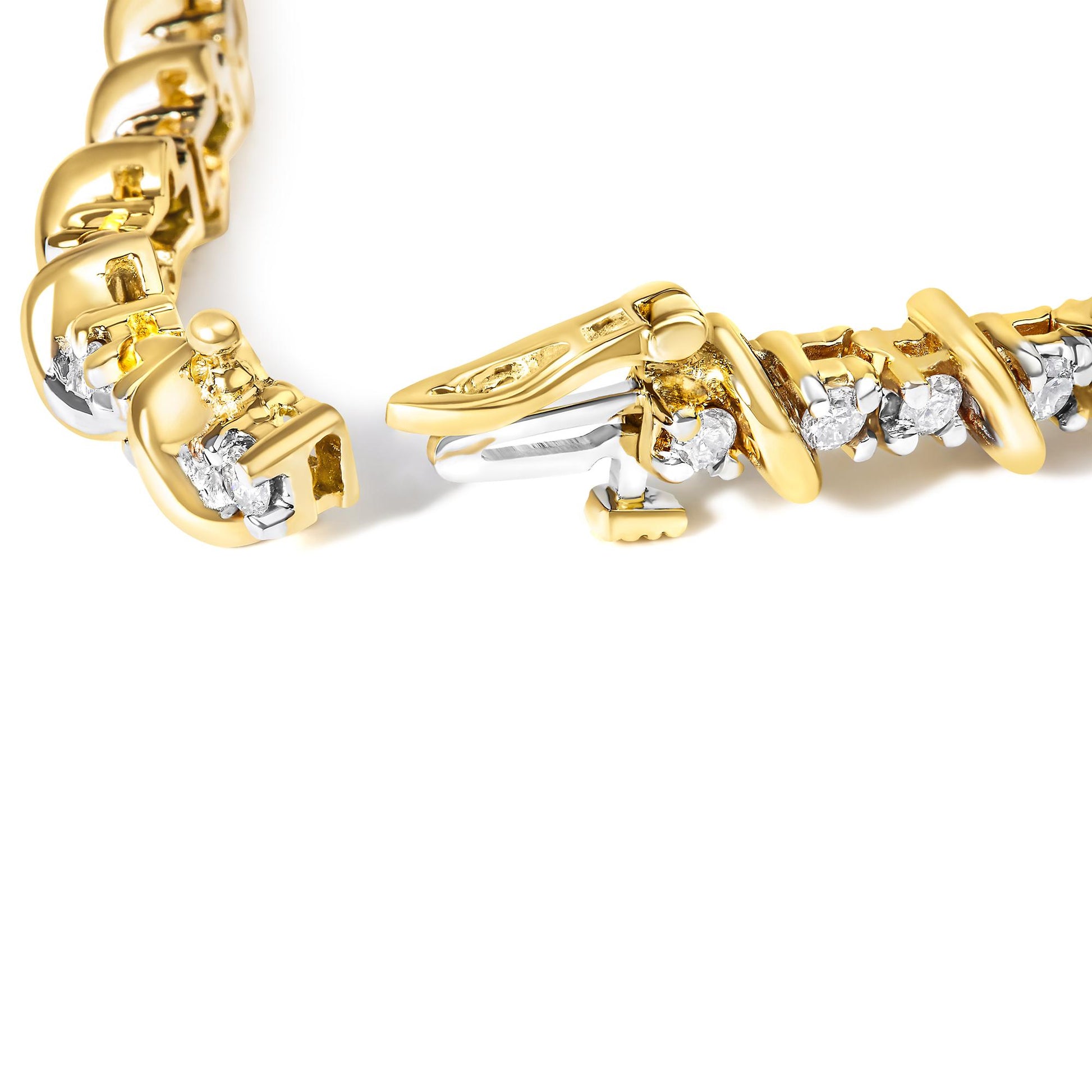 Close-up, top view of a yellow bracelet with round white gemstones in prong settings, partially opened clasp visible.