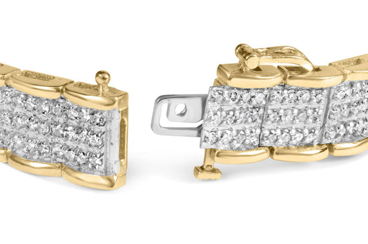 Close-up angled view of a yellow metal bracelet with sections encrusted with round white gemstones in prong settings, showing the clasp mechanism.