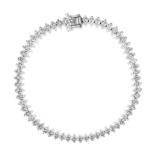 Top-down view of a white metal bracelet with round white gemstones set in 2-prong settings forming a continuous circle.