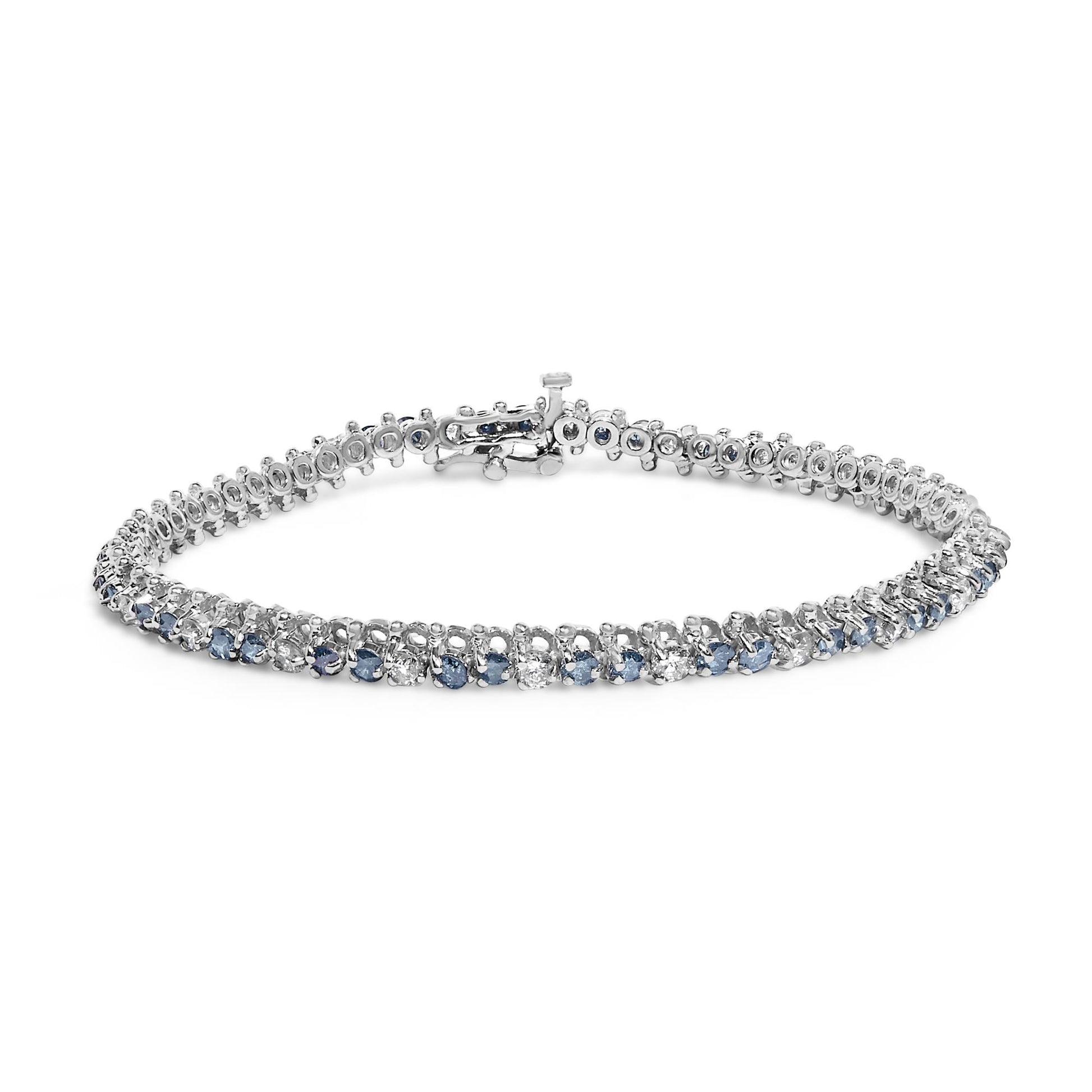 White metal bracelet with alternating white and blue round gemstones in 3-prong settings, shown from a front angle on a white background.