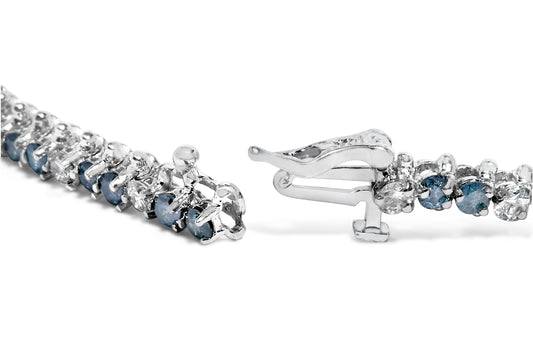 Close-up front angle of a white metal bracelet with alternating round white and blue gemstones in three-prong settings, showing the clasp open on a white background.