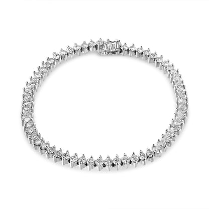 White metal tennis bracelet with round white gemstones in a 2-prong setting, displayed flat on a white background, top-down angle.