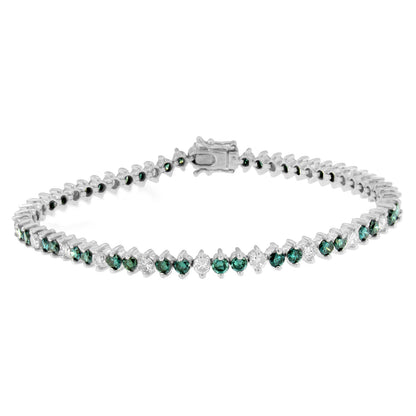 White metal bracelet with alternating round white and blue gemstones in prong settings, shown in a front angled view.