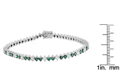 White metal bracelet with alternating round white and blue gemstones in prong settings, displayed flat with a ruler for size reference, shown from a front angle.