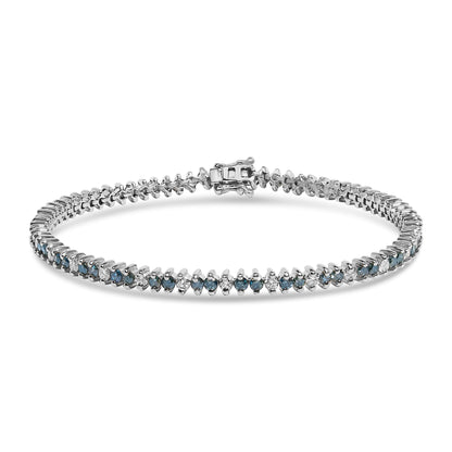 White metal tennis bracelet with alternating round white and blue gemstones in prong settings, shown in a front angled view with clasp visible.