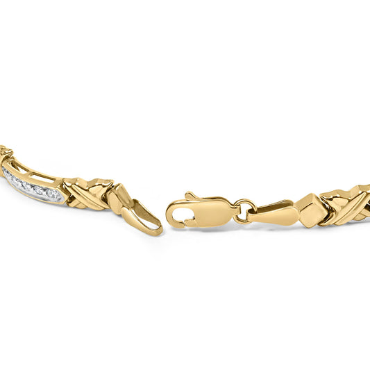 Close-up shot of an open yellow metal bracelet with white round gemstones in prong settings, shown against a white background.