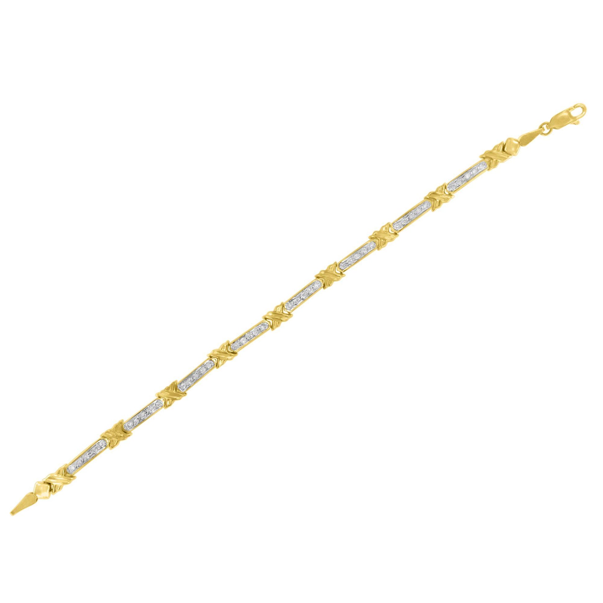 Yellow metal bracelet with alternating sections of white gemstones in prong setting and decorative yellow metal X-shaped links, shown from an angled top view.