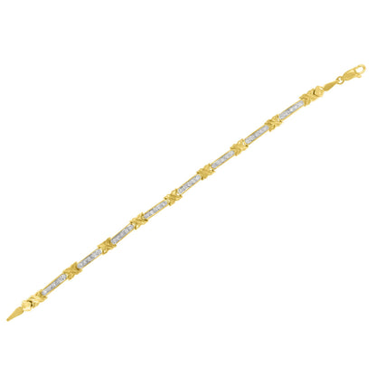 Yellow metal bracelet with alternating sections of white gemstones in prong setting and decorative yellow metal X-shaped links, shown from an angled top view.