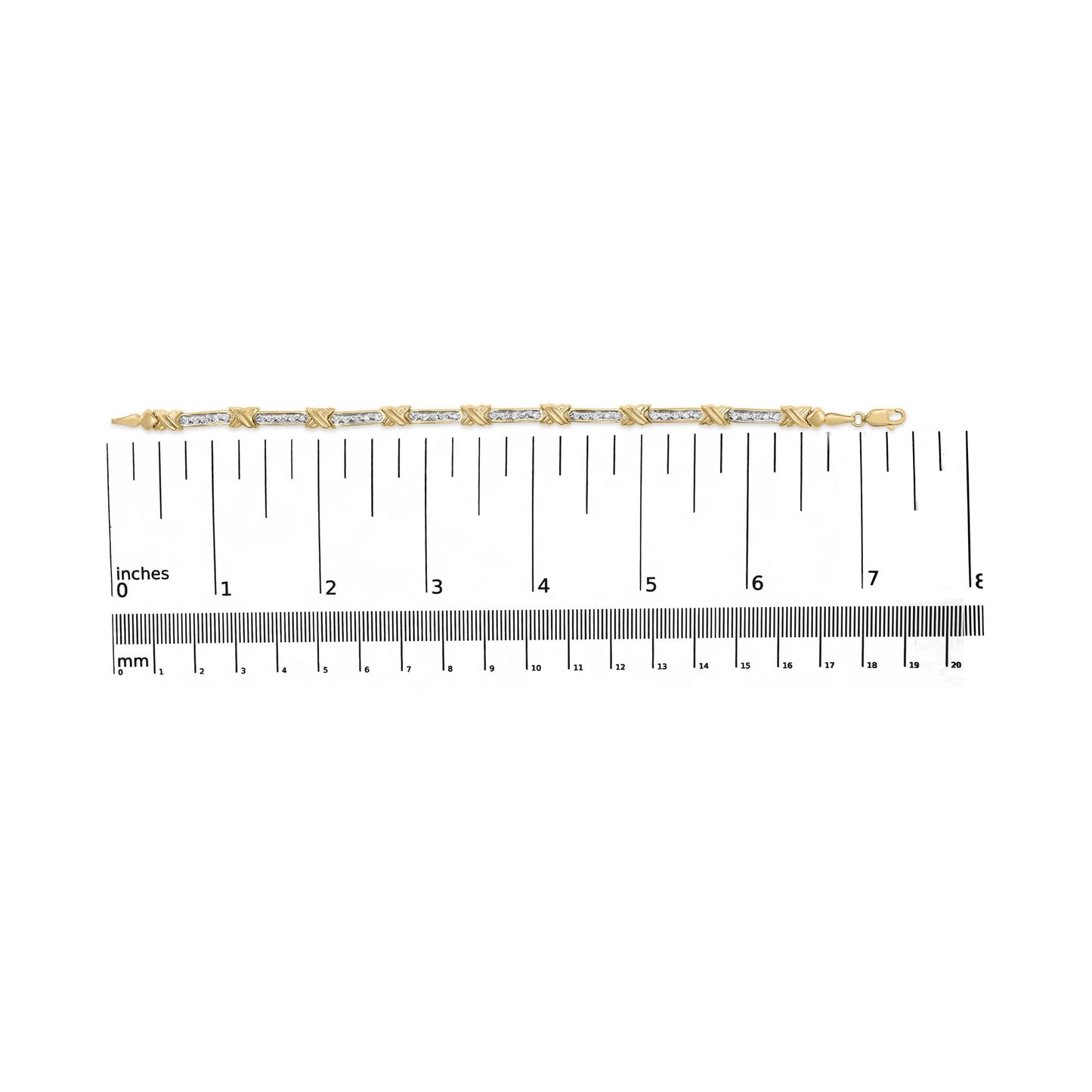 Yellow metal bracelet with alternating sections of white round gemstones in prong settings and solid links, shown flat on a ruler for size reference, top-down angle.