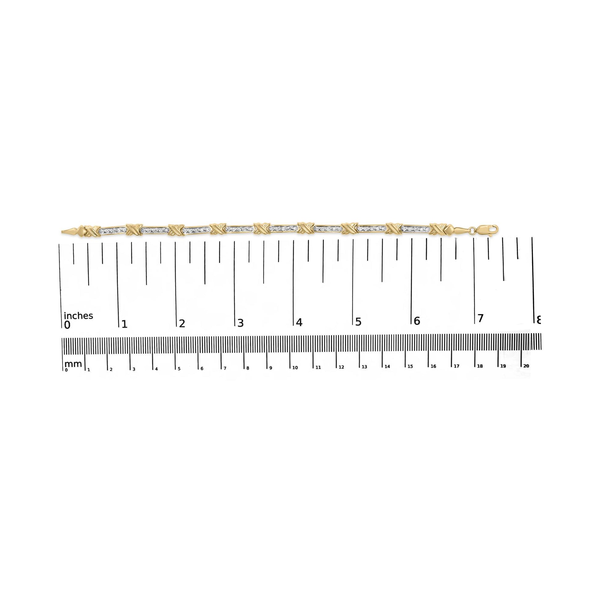Yellow metal bracelet with alternating sections of white round gemstones in prong settings and solid links, shown flat on a ruler for size reference, top-down angle.