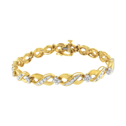Yellow metal bracelet with alternating twisted links and flower-shaped clusters of white gemstones, shown from a slightly angled top view.