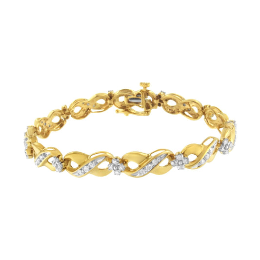 Yellow metal bracelet with alternating twisted links and flower-shaped clusters of white gemstones, shown from a slightly angled top view.