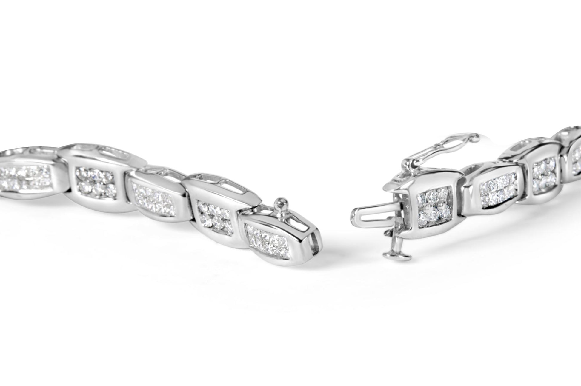 Close-up image of a white metal bracelet with sections featuring round white gemstones in prong settings and princess-shaped white gemstones in invisible settings, shown from a slightly angled top view with the clasp open.