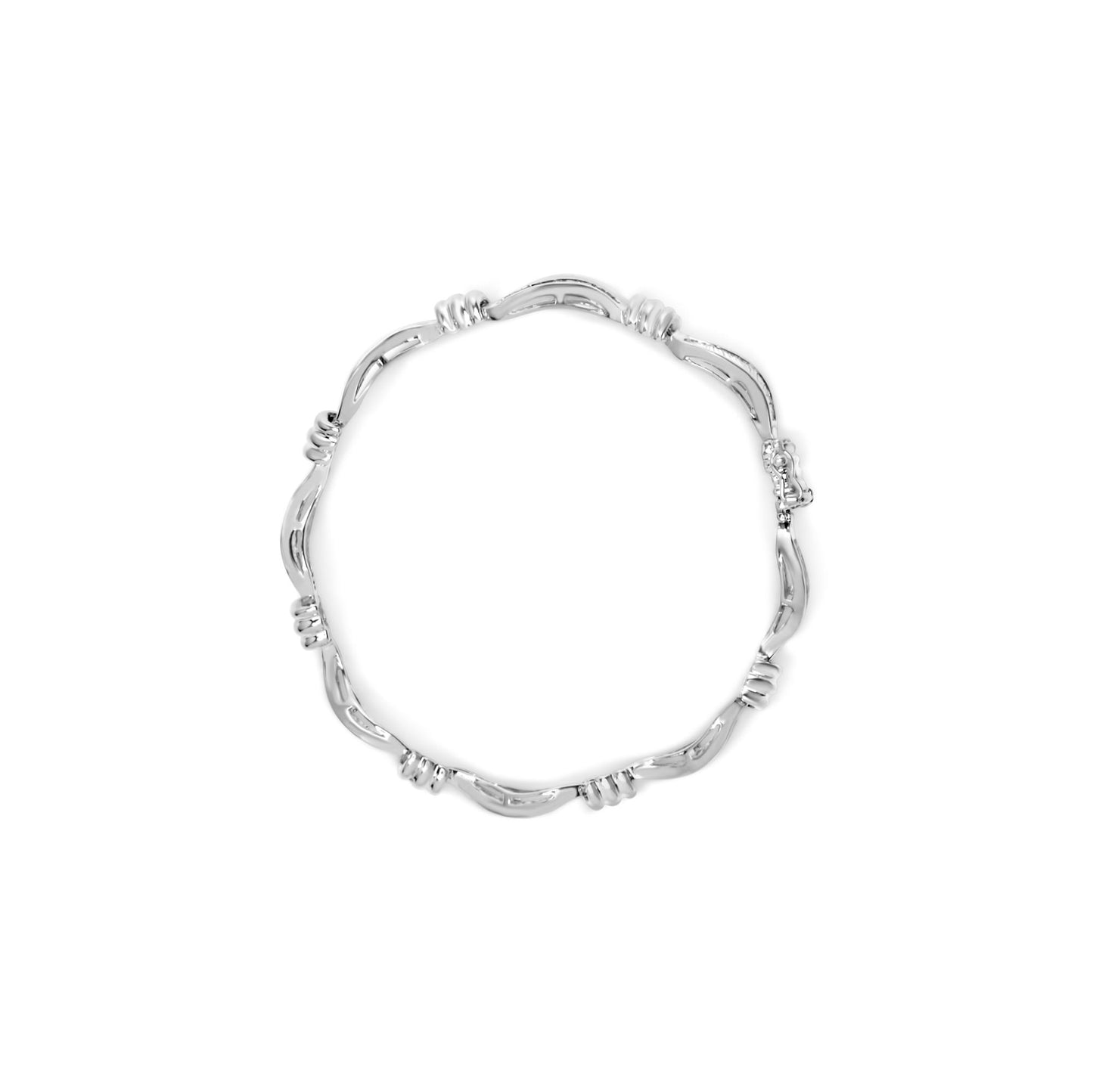 Top-down view of a white bracelet with a wavy design and clusters of baguette-shaped white gemstones set in channels along the band.