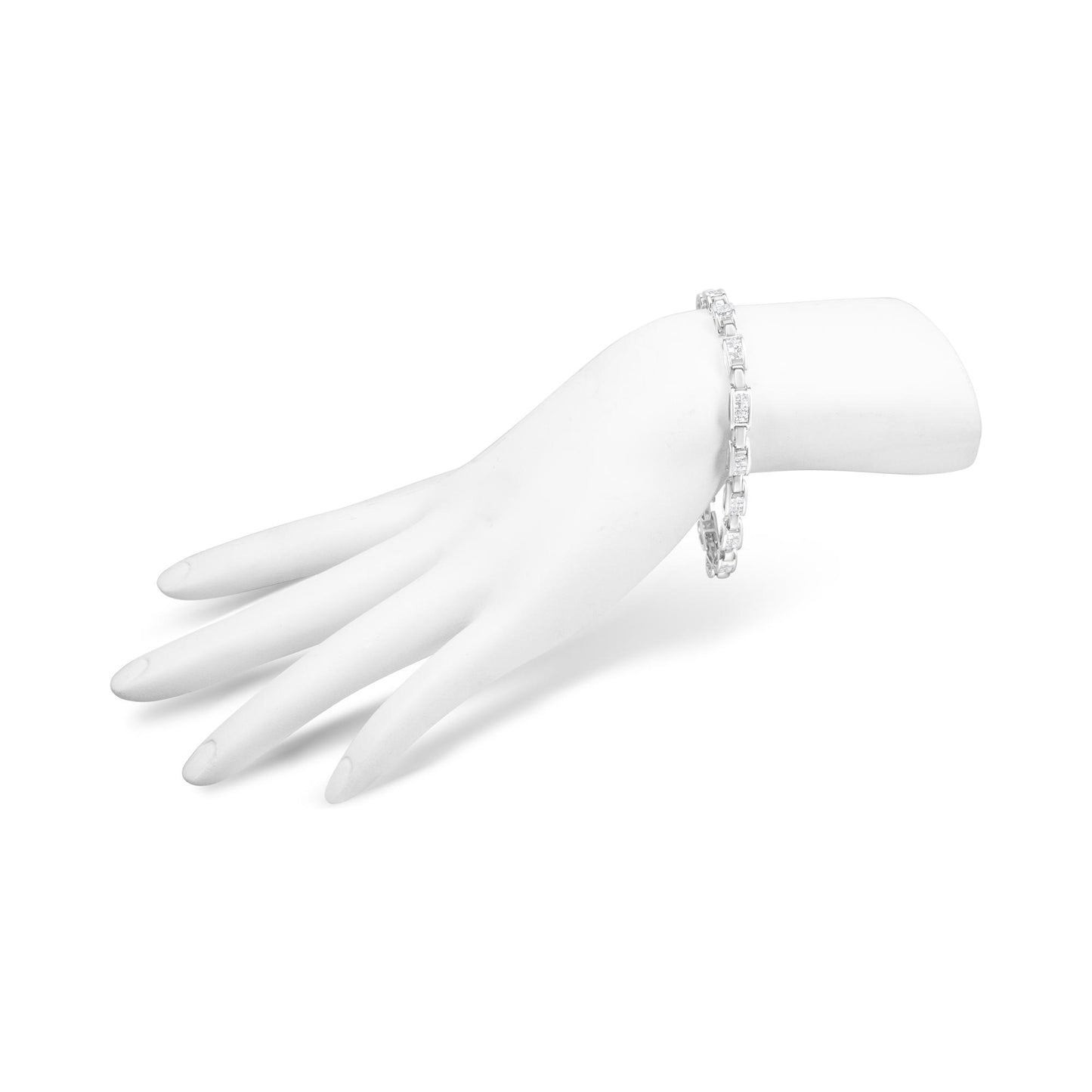 White metal bracelet with princess shape white gemstones in an invisible setting, shown worn on a model's hand angled to the side.