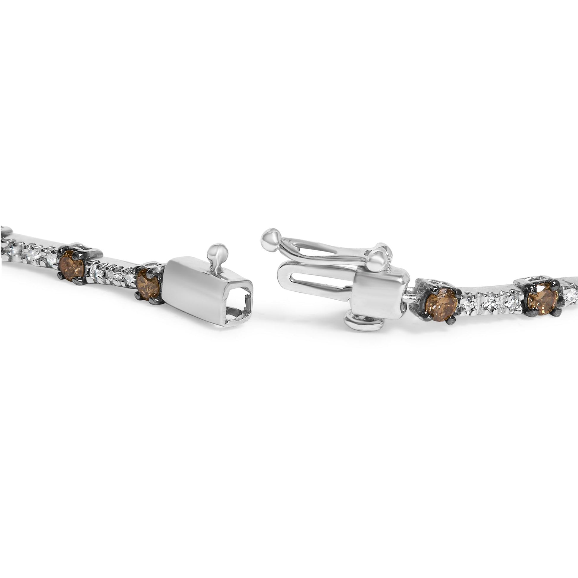 Close-up front angle of white metal bracelet with prong-set round champagne and white gemstones and a box clasp.