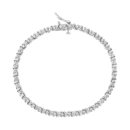 Top-down view of a white metal bracelet with round white gemstones in prong settings forming a continuous loop.