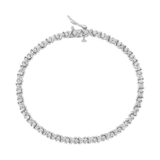 Top-down view of a white metal bracelet with round white gemstones in prong settings forming a continuous loop.