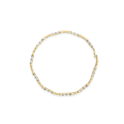 Top-down view of a yellow bracelet with round white gemstones set in a miracle setting along the band.